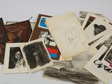a pile of old photos of people on a table