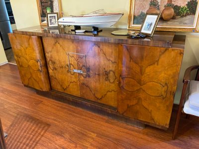 a large wooden cabinet with a boat on top of it