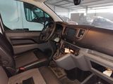 the interior of a van with a steering wheel and dashboard