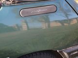 a close up of a green car with its hood up