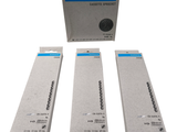 three boxes of cigarettes sitting next to each other on a white surface