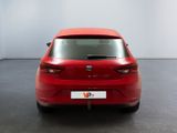 the rear end of a red car in a white room