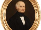 portrait of a man in a black suit and bow tie