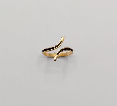 a close up of a gold ring on a white surface