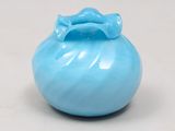 a small blue vase with a bow on top of it
