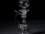 an old fashioned glass hooket with a glass handle on a black background