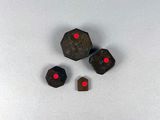 a close up of three dice pieces on a white surface