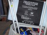 a pile of items in a box with a sign on it