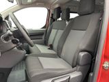the interior of a red truck with grey seats and a steering wheel
