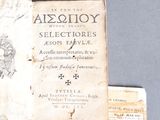 an old book that is open on a table