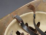 a close up of a helmet with a leather strap
