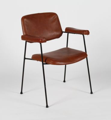 a brown leather chair with black legs and a black metal frame