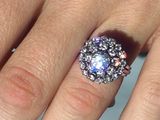 a close up of a person ' s hand with a ring on it
