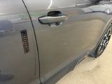 a close up of a car door handle with a sticker on it