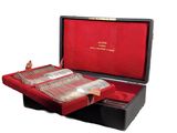 a red case with silverware in it on a white surface