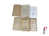 three open books sitting on top of each other on a white surface