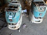 two machines that are sitting on the ground