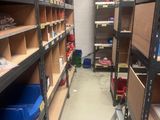 a room with a lot of shelves and bins in it