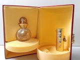 a bottle of perfume sitting in a box on a table