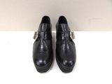 a pair of black leather shoes with buckles on them