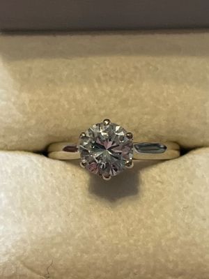 a close up of a diamond ring in a box on a table
