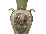 a green vase with a face on it on a white background