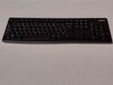 a black keyboard sitting on top of a white table