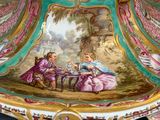 a large bowl with a lid that has a painting on it