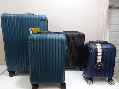 three pieces of luggage that are sitting on a table