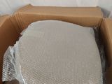 a cardboard box filled with plastic material on a white surface