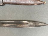 two knives that are sitting next to each other on a table
