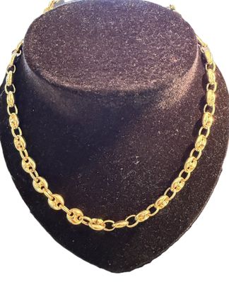 a close up of a hat with a necklace on a mannequin