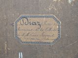 an old book with writing on it sitting on a table