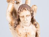 an old statue of a man holding a tree branch in his hands
