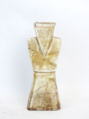 a glass vase that has a gold colored design on it