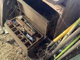 a wooden box with tools in it next to a pile of wood