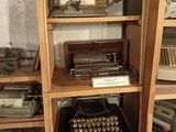 many old typewriters and typewriters on display in a room
