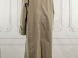 the back view of a beige trench coat on a mannequin mannequin