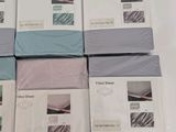 several sheets of bedding are stacked on top of each other