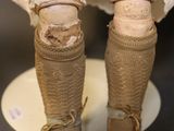 a close up of a doll ' s legs and shoes
