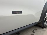 a sticker on the side of a white car