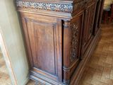 a wooden bar in the middle of a tiled floor