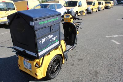 many yellow and black vehicles parked in a parking lot