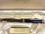 a pen in a box with a name tag on it