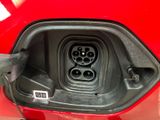 a close up of an electric car plugged in to a red vehicle