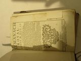 an old book with a picture of a coat of arms on top of it