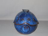 a small blue pig shaped box on a white surface