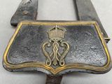 a metal belt with a metal buckle and a crown on it
