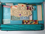 a blue suitcase with a lot of money inside of it