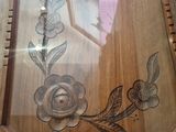 a picture of a wooden frame with a picture of a rose on it